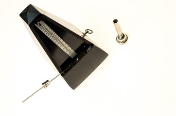 Metronome and mouthpiece of a trumpet isolated on a blank white