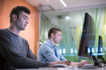 technology students group working  in computer lab school  class