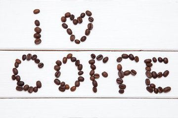 Coffee beans arranged in the word i like coffe.