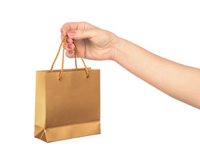 female hand hold a gold gift bag isolated on white background