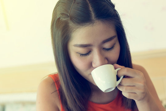 female drinking hot coffee in cafe