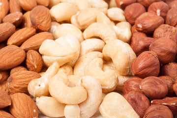 almonds cashews and hazelnuts peeled as background