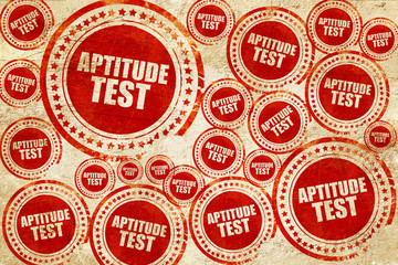 aptitude test, red stamp on a grunge paper texture