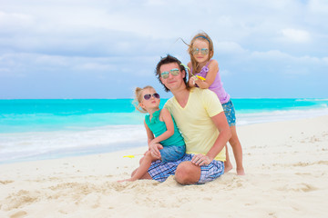 Fototapeta na wymiar Happy family on tropical beach having fun together