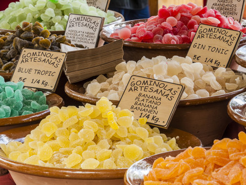 Traditional sweets (gominolas artesanas) made out of dried fruit (banana, blueberry) with sugar for sale on a market stand at Majorca,Spain, Europe - overview