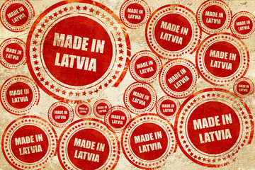 Made in latvia, red stamp on a grunge paper texture