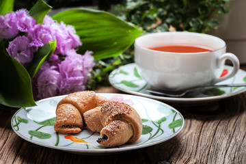 Breakfast with croissants, cup of tea.