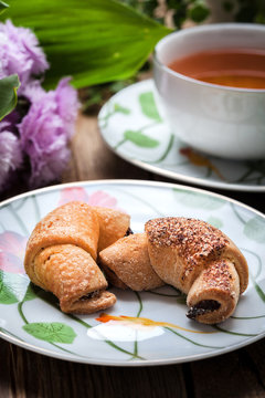 Breakfast with croissants, cup of tea.