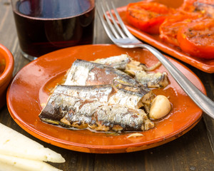 sardines appetizer earthenware dish on wood