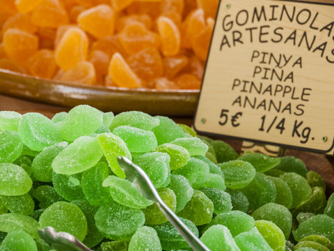Traditional sweets (gominolas artesanas) made out of dried pineapple with sugar for sale on a market stand at Majorca,Spain, Europe -  no people, close-up