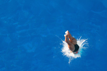 Splash. Diver entering the water. Shot from above
