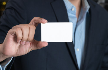 Business man handing a blank business card 
