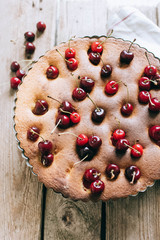 Creme brownie cake with cherry on a wooden board