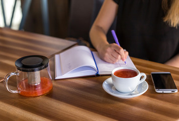 woman drinking tea and working with business papers