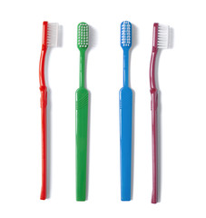 A selection of coloured tooth brushes isolated on a white background 