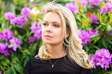 Portrait of beautiful blond woman in spring blossom