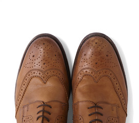 Mens brown leather brogues isolated on a white background