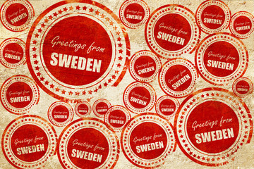 Greetings from sweden, red stamp on a grunge paper texture