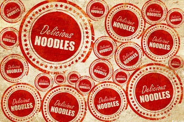 Delicious noodles sign, red stamp on a grunge paper texture