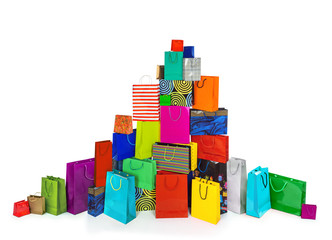 a huge pile of multi-colored bags for shopping isolated on white