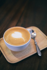 Late art coffee on wood table background