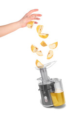 apples fall into the juicer on white