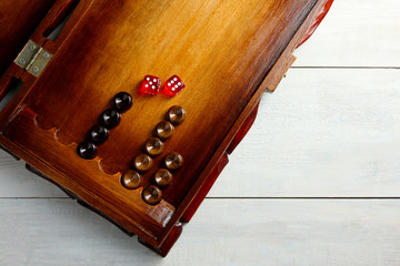 old backgammon with dice closeup on white wooden background