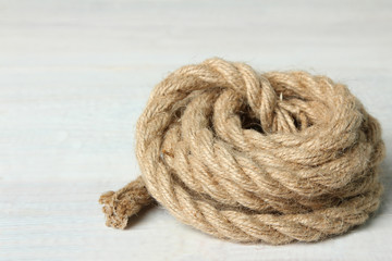 folded rope on a  white wooden background