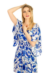 blonde posing in blue dress with a floral pattern