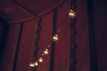 Blurred image of string wired bulbs inside dark room