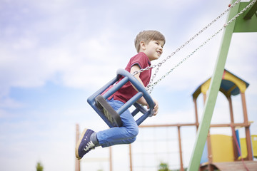 Little boy enjoying the time on the playground