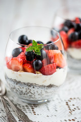 chia seeds in yogurt with granola, yogurt and strawberries, blue