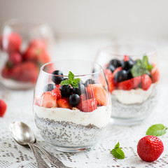 chia seeds in yogurt with granola, yogurt and strawberries, blue