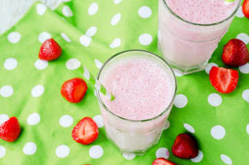 
Summer refreshing cold drink , a milkshake with strawberries on a bright color background