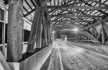 Car light trails inside a bridge at night