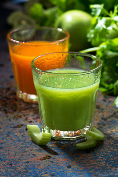 glasses of fresh juice from celery and carrots, vertical