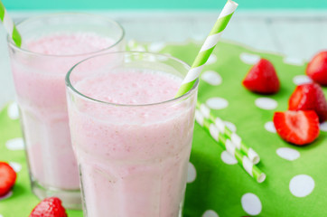 
Summer refreshing cold drink , a milkshake with strawberries on a bright color background