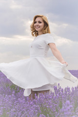 Fototapeta premium Beautiful young dancing woman portrait on lavender field