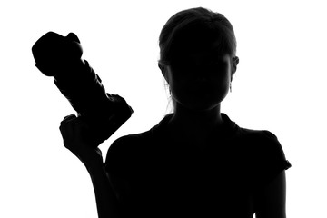 silhouette of a woman with a camera in hand