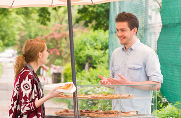 Man selling pizza by slice