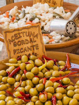 Traditional green olives mixed with red bell pepper for sale on a market at Majorca,Spain, Europe - close-up
