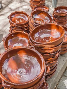 Traditional pottery for cooking made out of clay for sale on a market stand at Majorca,Spain, Europe - close-up