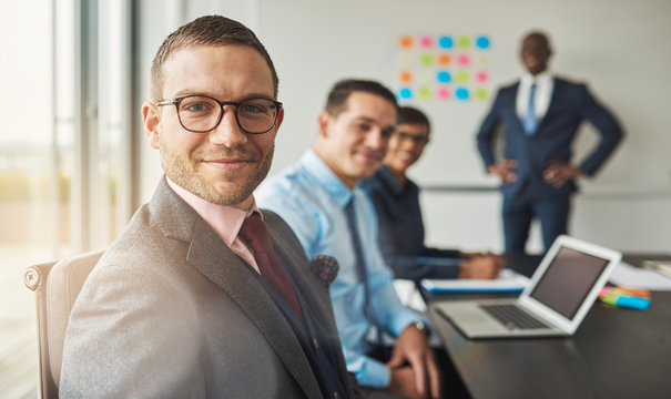 Handsome man with three co-workers in meeting