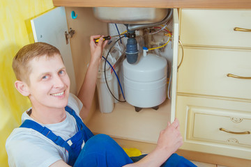 Plumber installs a water filter. water filter.