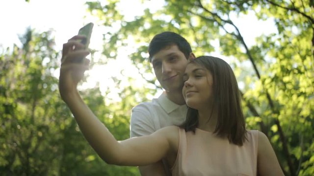 Joyful man and woman doing selfie phone