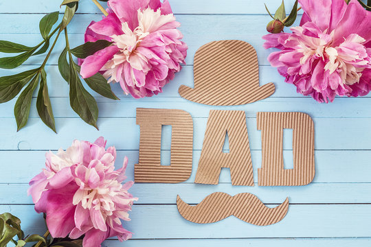 Fathers day background with cardboard letters and purple peonies