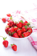 fresh strawberry in white bowl with the napkin