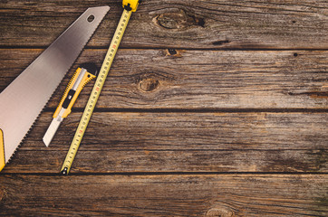 Construction equipment and tools on wooden table. Concept photograph taken from above, top view.