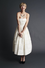 Joyful bride looking up in studio