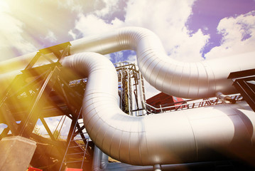 Industrial zone, Steel pipelines and valves against blue sky